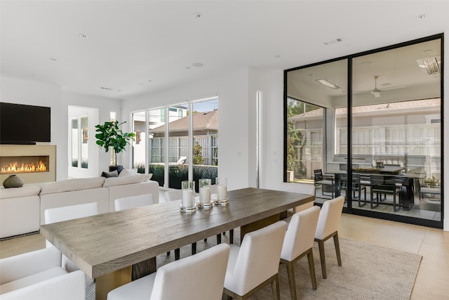 dining space featuring light tile patterned floors and ceiling fan