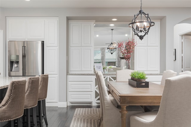 dining area featuring an inviting chandelier and dark hardwood / wood-style flooring