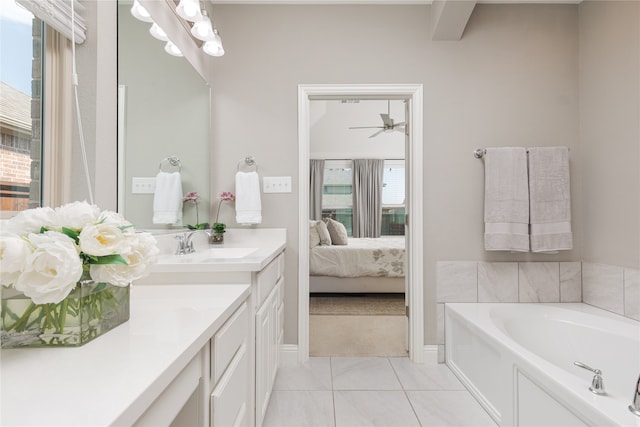 bathroom with a washtub, vanity, tile patterned floors, and ceiling fan