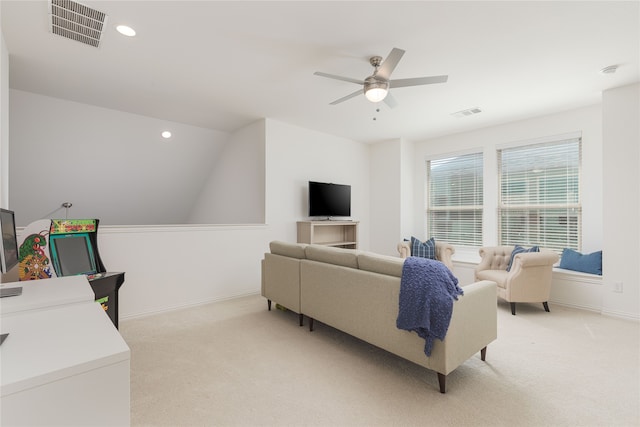 living room with lofted ceiling, light carpet, and ceiling fan