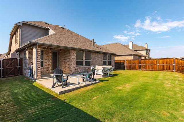 back of property featuring a patio and a lawn