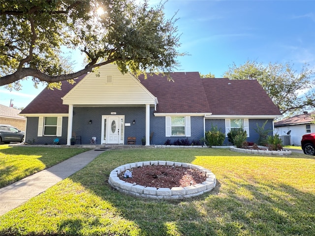 ranch-style house featuring a front lawn and central air condition unit