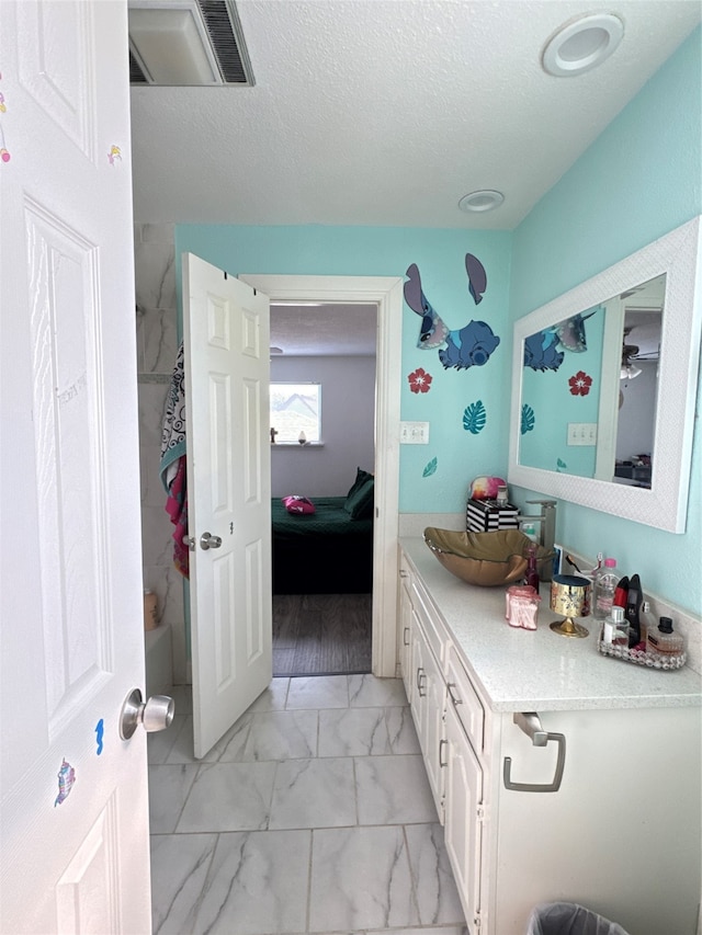 bathroom with shower / washtub combination, vanity, a textured ceiling, and hardwood / wood-style flooring