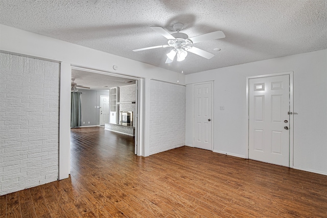 empty room featuring ceiling fan, a textured ceiling, and hardwood / wood-style flooring