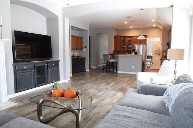 living room featuring vaulted ceiling and dark hardwood / wood-style floors