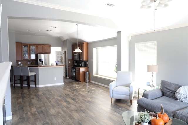 living room with lofted ceiling, ornamental molding, and dark hardwood / wood-style floors