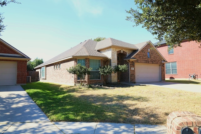 view of front of house featuring a front yard and a garage