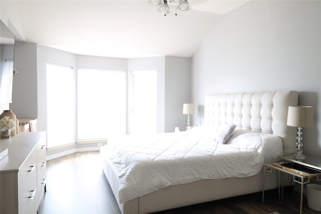 bedroom with hardwood / wood-style flooring and vaulted ceiling