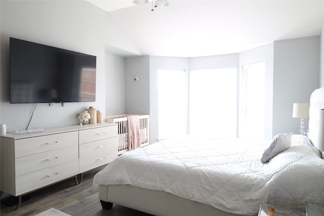 bedroom featuring lofted ceiling and dark hardwood / wood-style flooring