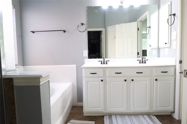 bathroom with vanity, a tub, and tile patterned flooring