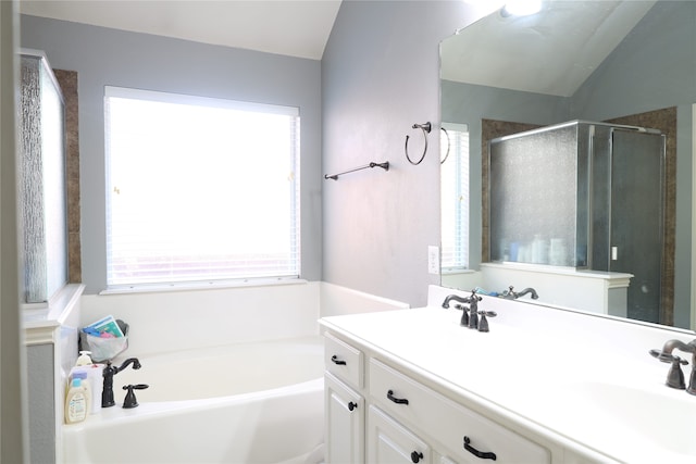 bathroom featuring vanity, lofted ceiling, and plus walk in shower