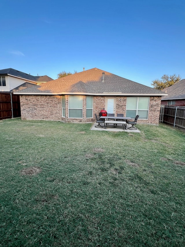 rear view of house featuring a patio area and a yard