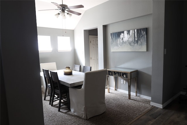 dining space with dark wood-type flooring, ceiling fan, and vaulted ceiling