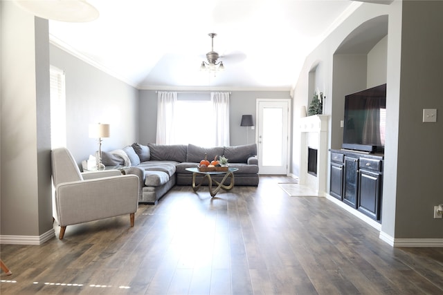 living room featuring ceiling fan, ornamental molding, vaulted ceiling, and dark hardwood / wood-style floors