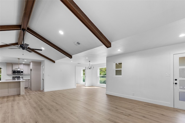 unfurnished living room with lofted ceiling with beams, ceiling fan with notable chandelier, and light hardwood / wood-style floors