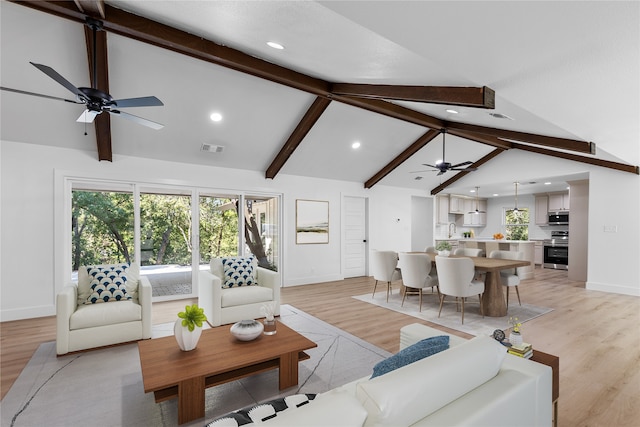 living room with beam ceiling, light hardwood / wood-style flooring, and ceiling fan