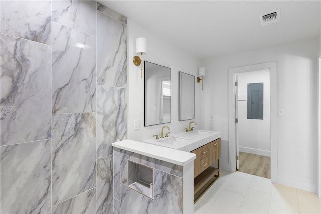 bathroom featuring vanity, electric panel, and tile patterned floors