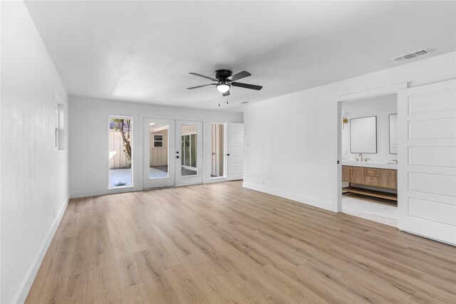 320 Arapaho W, Sherman, TX 75092 - unfurnished living room featuring baseboards, light wood-type flooring, a ceiling fan, and french doors