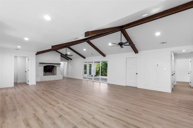 unfurnished living room featuring lofted ceiling with beams, light hardwood / wood-style flooring, a fireplace, and ceiling fan