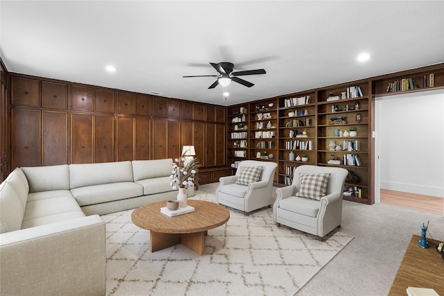 living room featuring light colored carpet and ceiling fan