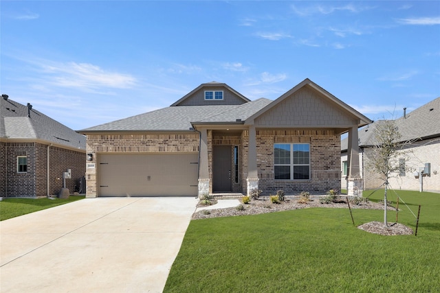 view of front facade featuring driveway, a front yard, a shingled roof, a garage, and brick siding