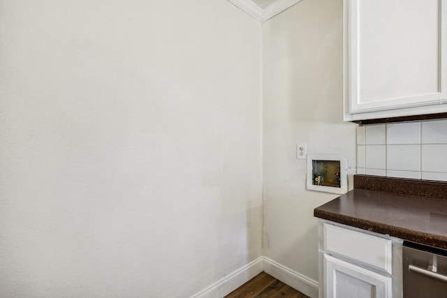 clothes washing area with ornamental molding, dark wood-type flooring, and hookup for a washing machine