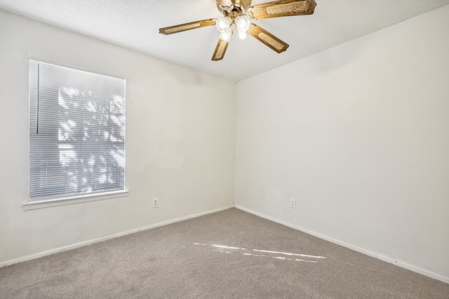 carpeted empty room featuring ceiling fan