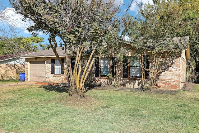 obstructed view of property featuring a garage and a front lawn