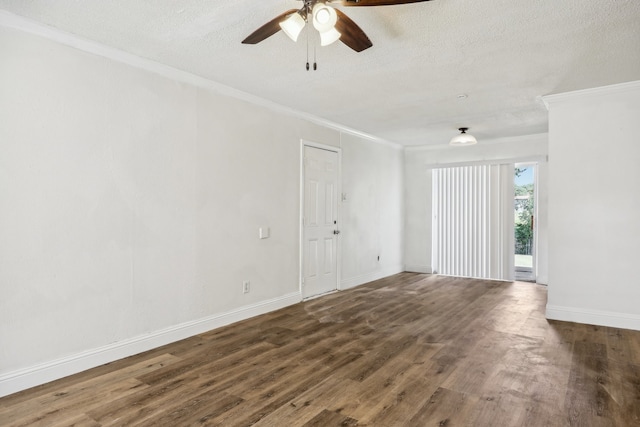 empty room featuring dark hardwood / wood-style flooring, ornamental molding, and a textured ceiling