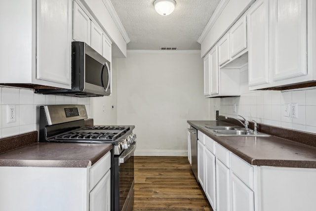 kitchen featuring dark wood-type flooring, sink, white cabinets, and stainless steel appliances