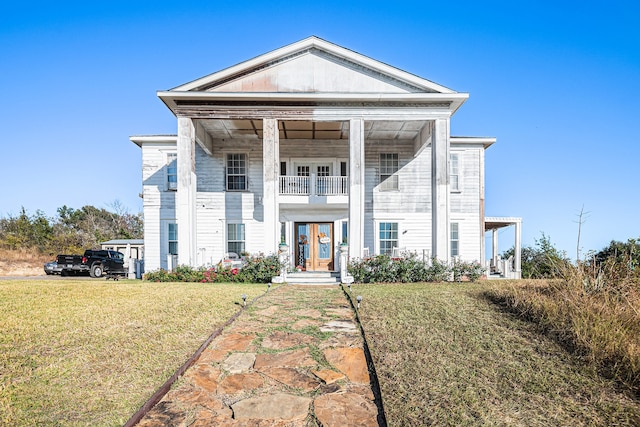 neoclassical / greek revival house with a front lawn