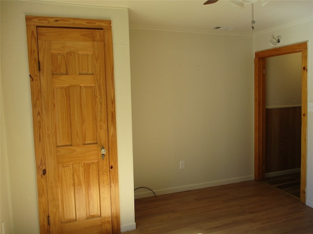 spare room with ornamental molding, hardwood / wood-style flooring, and ceiling fan