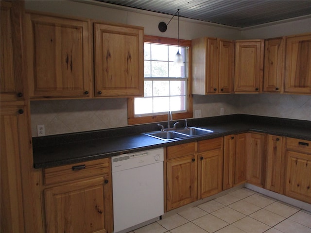 kitchen with decorative backsplash, hanging light fixtures, light tile patterned floors, dishwasher, and sink