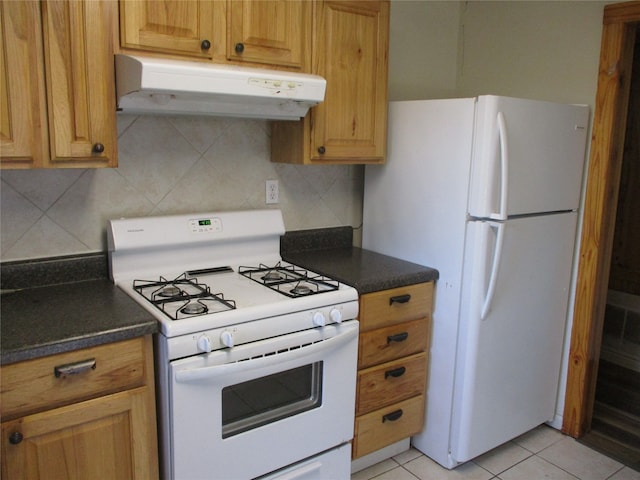 kitchen with white appliances, tasteful backsplash, and light tile patterned flooring