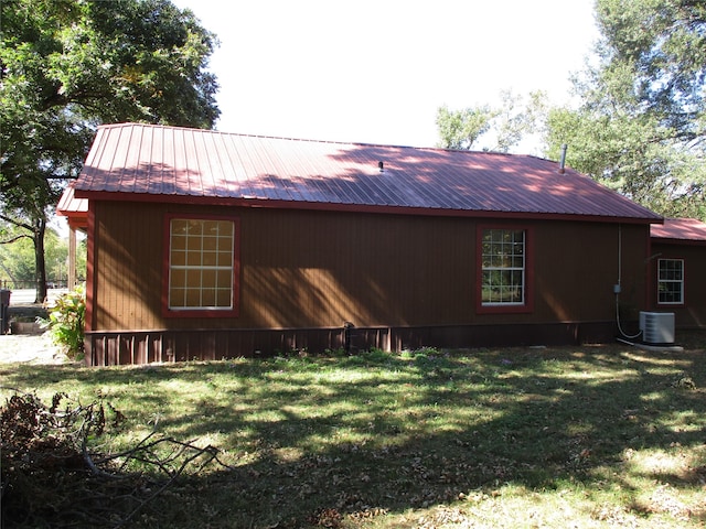 view of property exterior featuring a yard and cooling unit