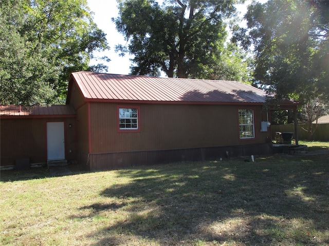 back of house with a lawn