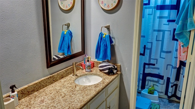 bathroom featuring vanity and a shower with shower curtain