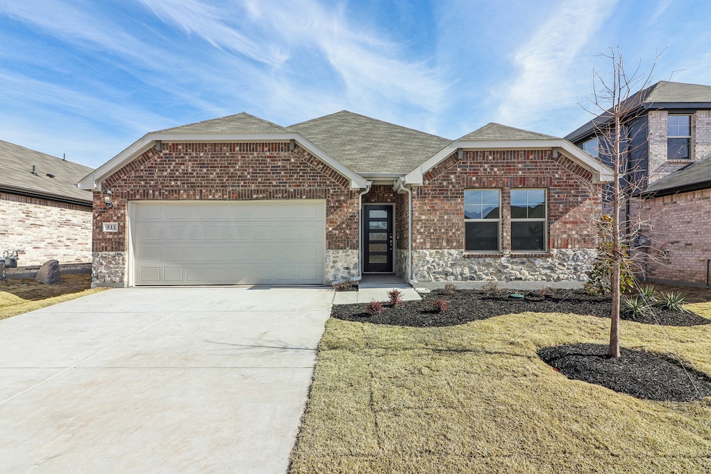 view of front of property with a garage and a front yard