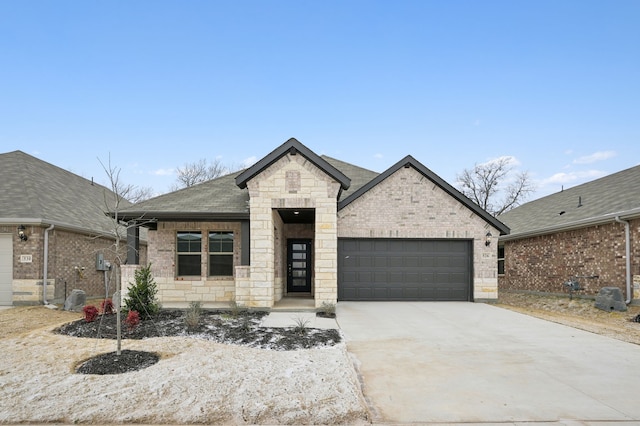 view of front of property with a garage, driveway, brick siding, and roof with shingles