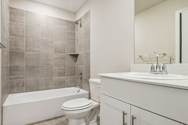 full bathroom with toilet, vanity, tiled shower / bath, and tile patterned floors