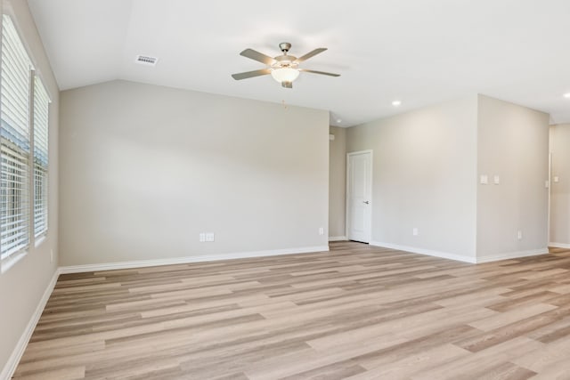 spare room with ceiling fan, light hardwood / wood-style flooring, and vaulted ceiling