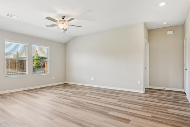 empty room featuring a ceiling fan, light wood-type flooring, visible vents, and baseboards