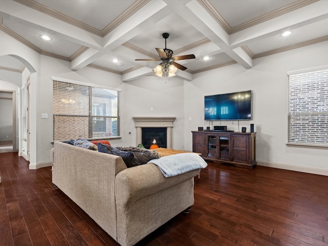 living room with ornamental molding, beamed ceiling, and dark wood-type flooring