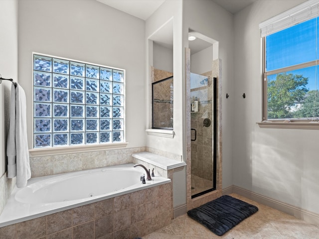 bathroom featuring shower with separate bathtub, a healthy amount of sunlight, and tile patterned floors