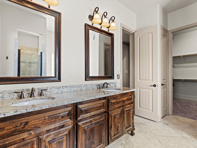 bathroom featuring vanity, tile patterned floors, and walk in shower