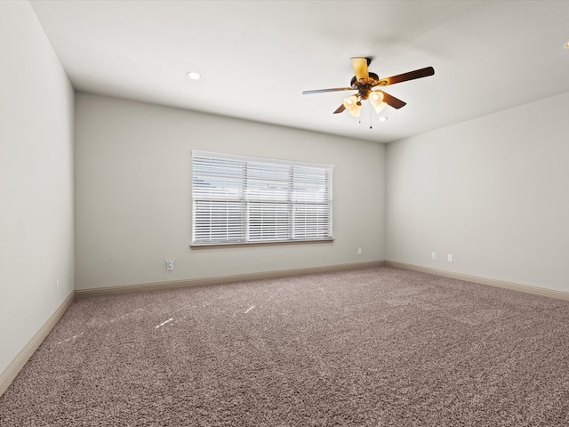 carpeted spare room with ceiling fan