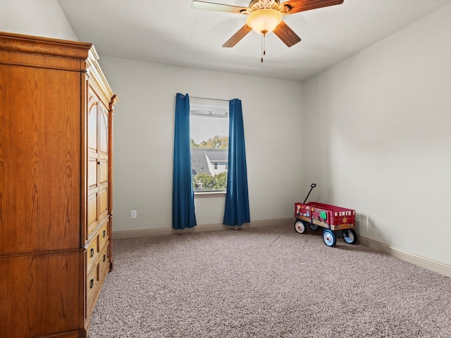 rec room with ceiling fan and carpet