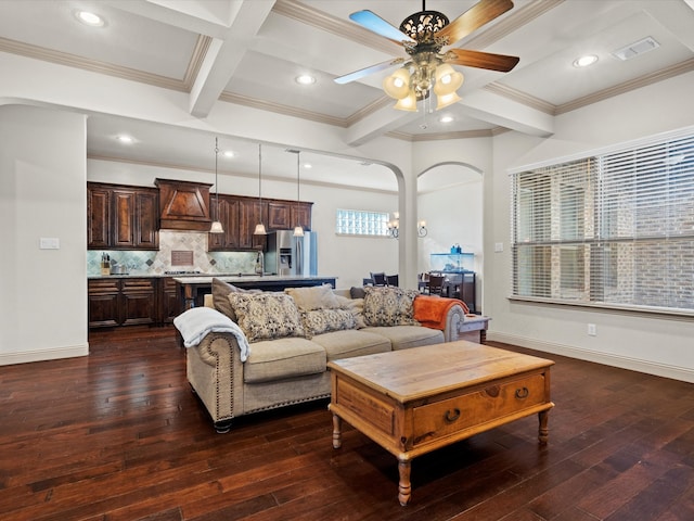 living room featuring ceiling fan, ornamental molding, dark hardwood / wood-style floors, beamed ceiling, and coffered ceiling