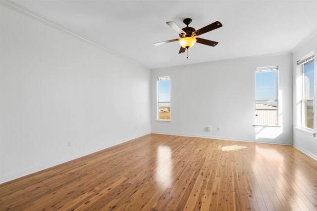 unfurnished room with crown molding, light wood-type flooring, and ceiling fan