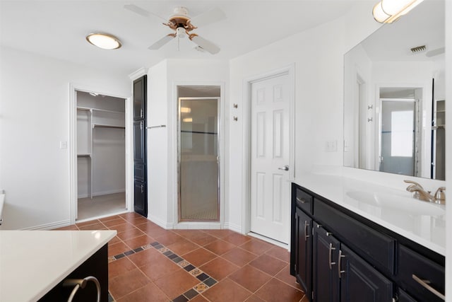 bathroom with vanity, an enclosed shower, ceiling fan, and tile patterned flooring